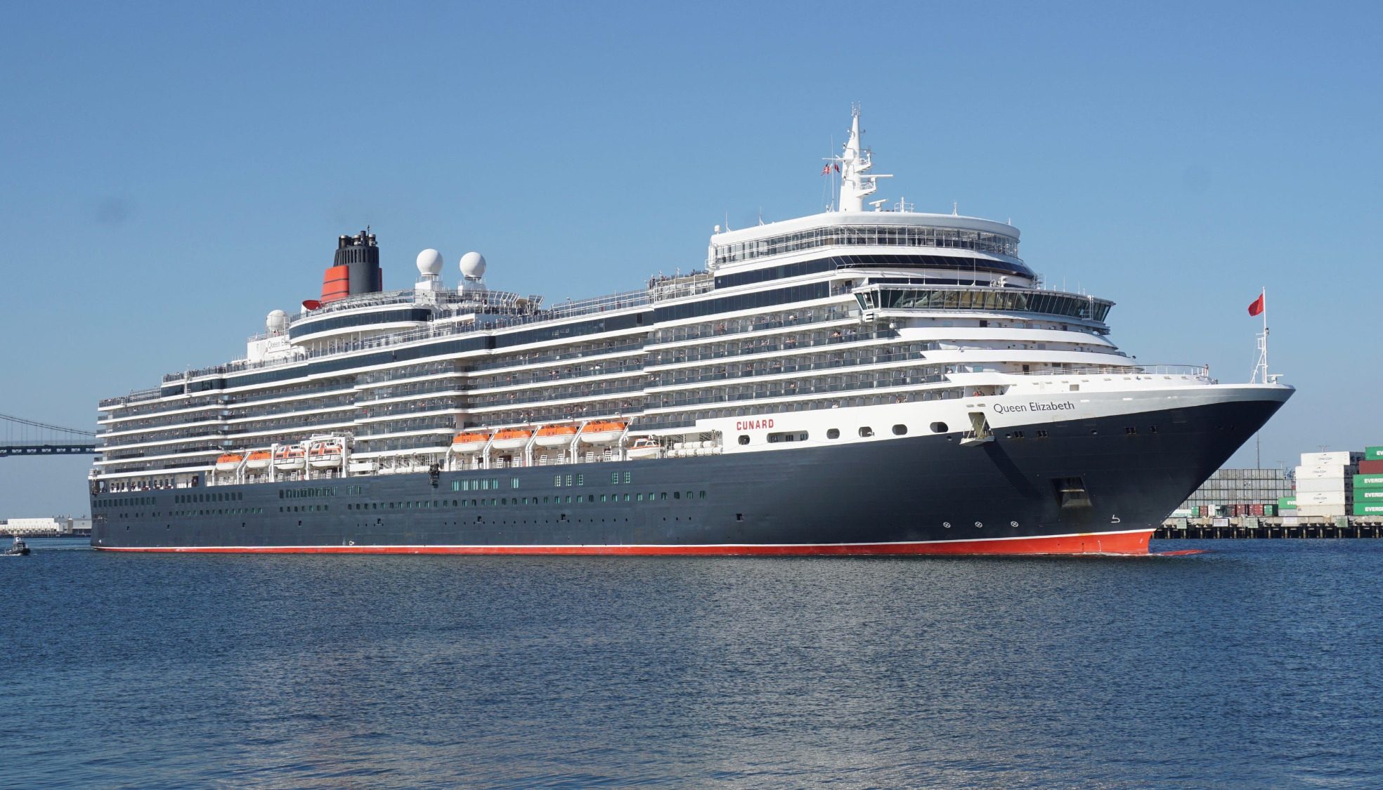 Costa Fascinosa Costa Favolosa Large cruise ship docked by the harbor under clear blue skies.