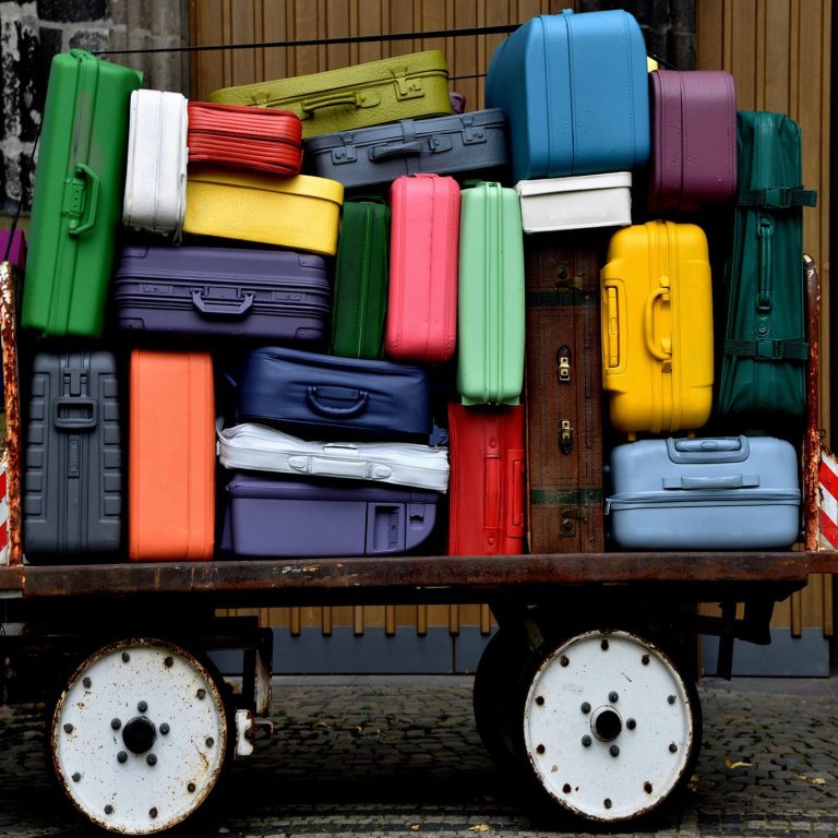 Explore shopping-focused vacations worldwide Shopping traveler with colorful luggage at airport during vacation