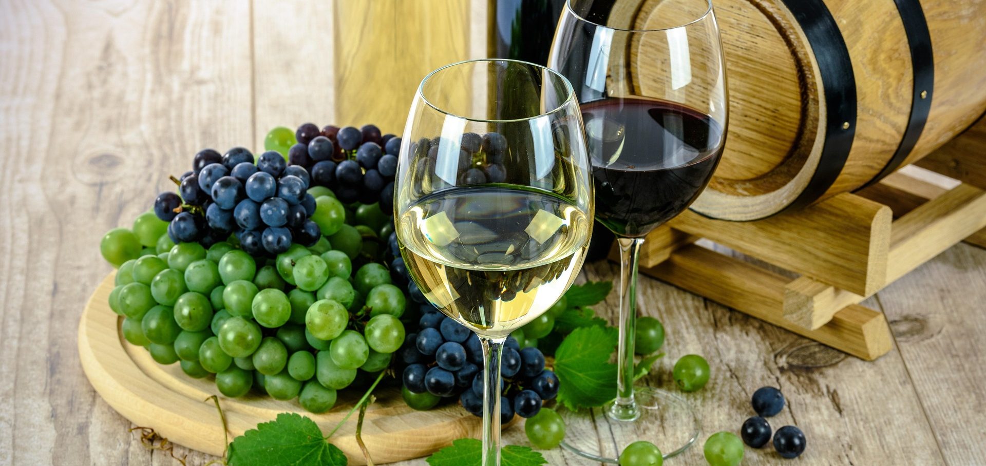 Wine glasses on a table overlooking vineyard hills