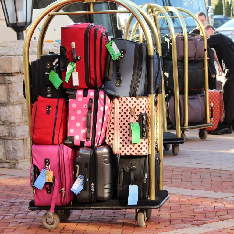 vacation traveler drops off luggage to be picked up by hotel staff