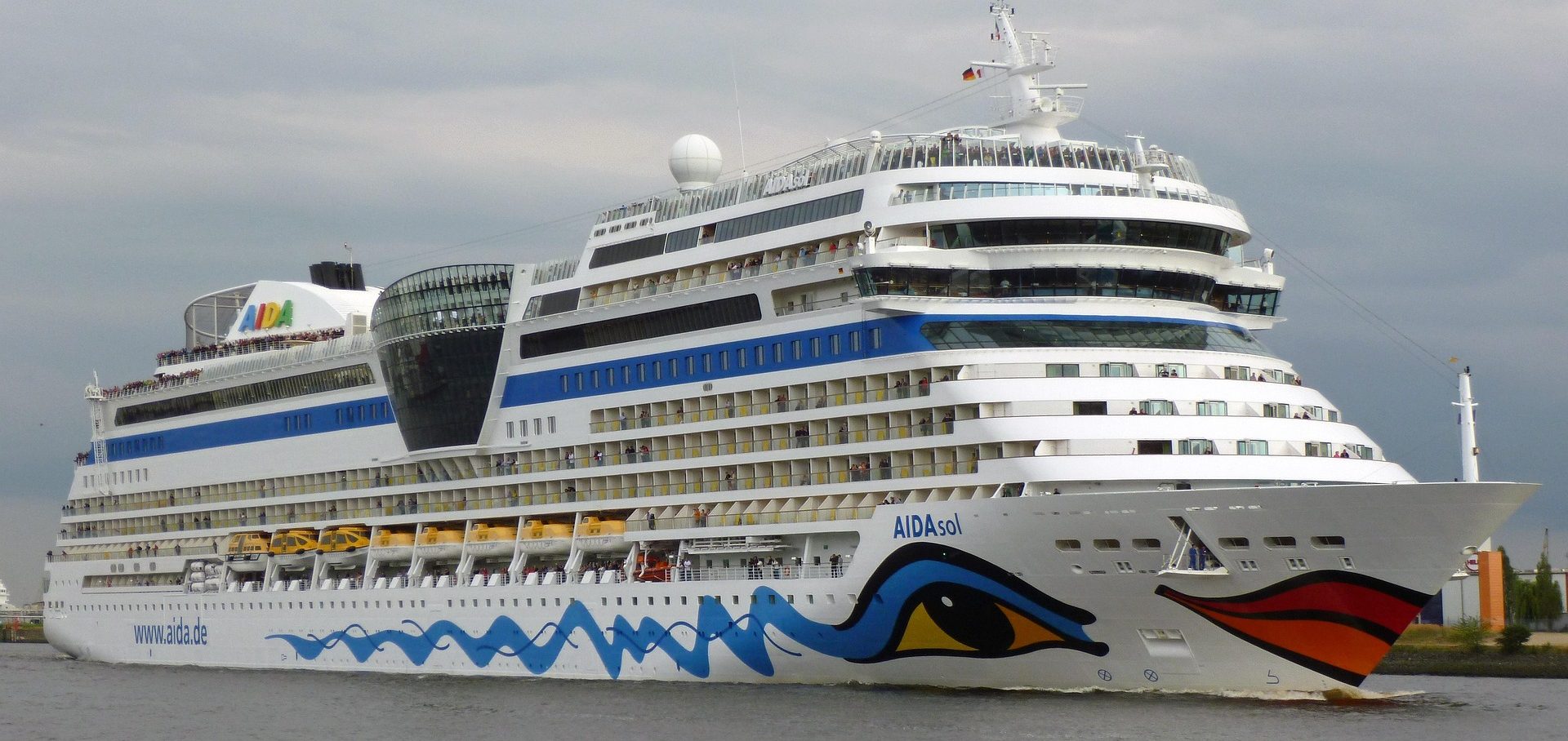 A grand cruise liner sets sail from a tropical destination, marking the start of a dream vacation.