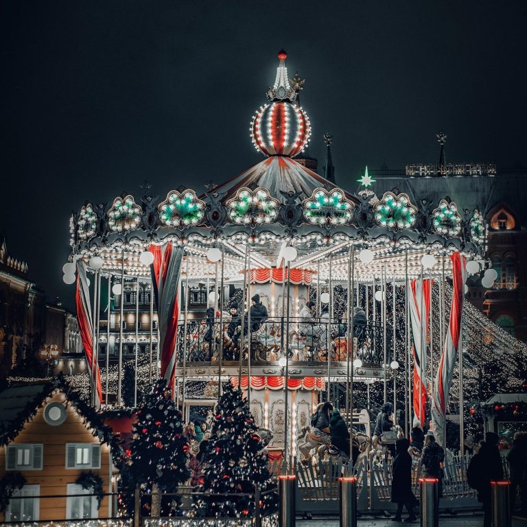 Family Vacation A beautifully lit carousel with holiday decorations and a snowy backdrop.