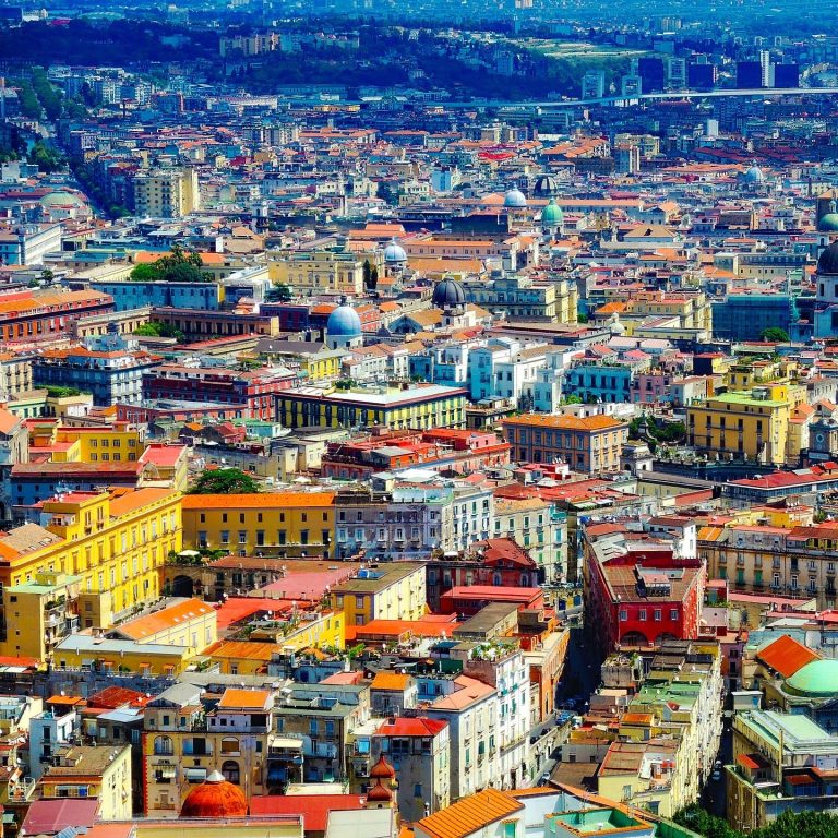 Urban Vacation Aerial view of a colorful urban landscape featuring historic buildings and rooftops.