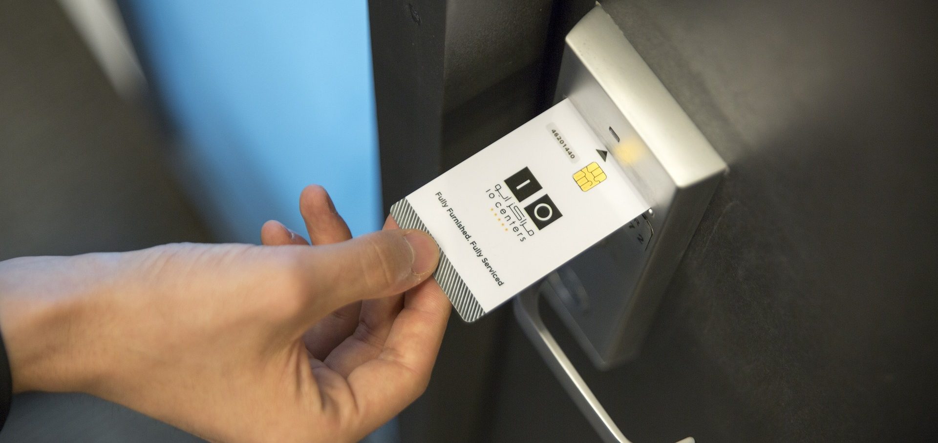 Traveler locking hotel room door with luggage inside for safety and security