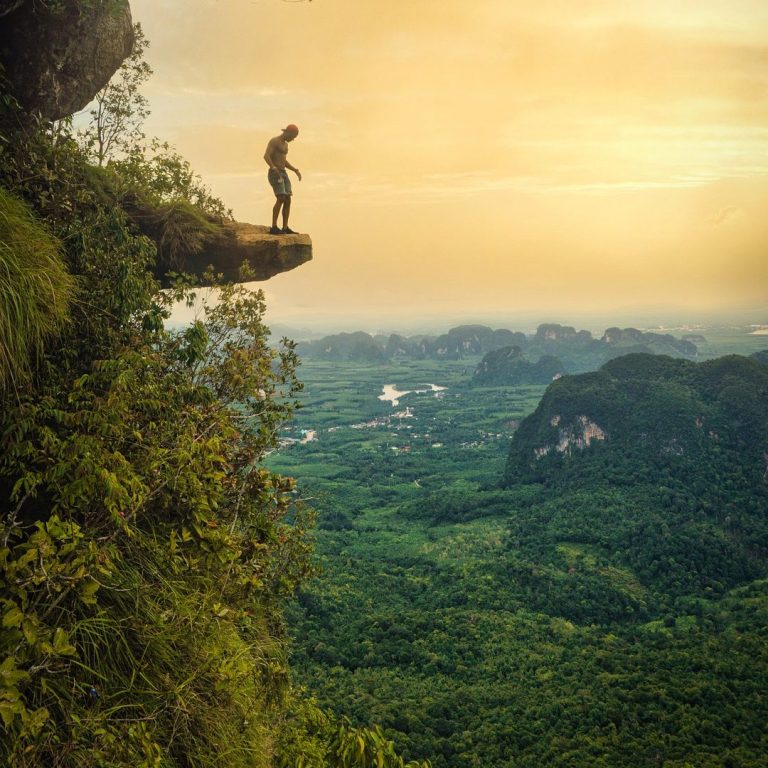 Thrilling adventure travel packages for explorers Adventure explorer traveler overlooking valley on rugged hike