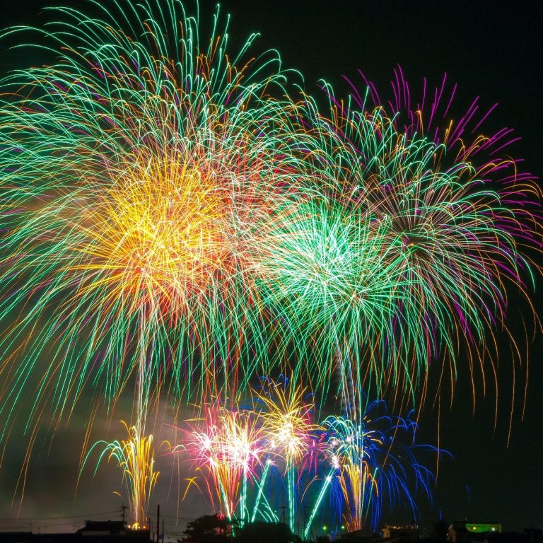 Festival & Event Vacation Colorful fireworks illuminate the night sky in various vibrant hues.