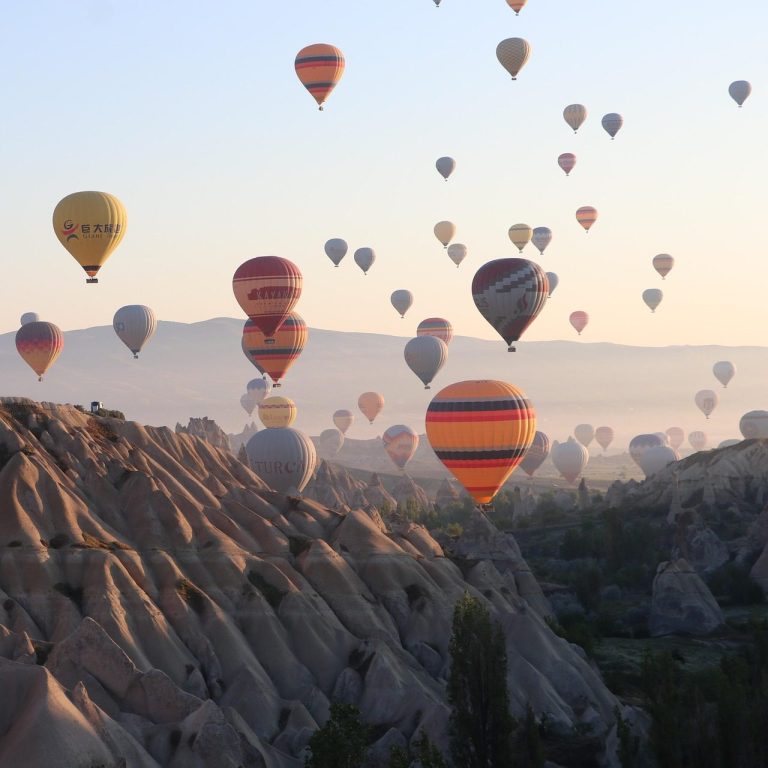 Travel to global festivals and cultural events Festival traveler experiencing hot air balloon event at sunrise